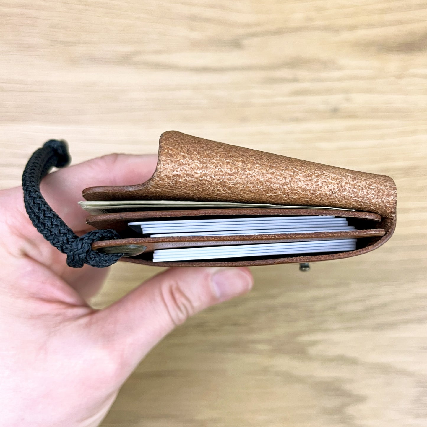 OCEANUS minimalist wallet open — 12 card slots and notes compartment