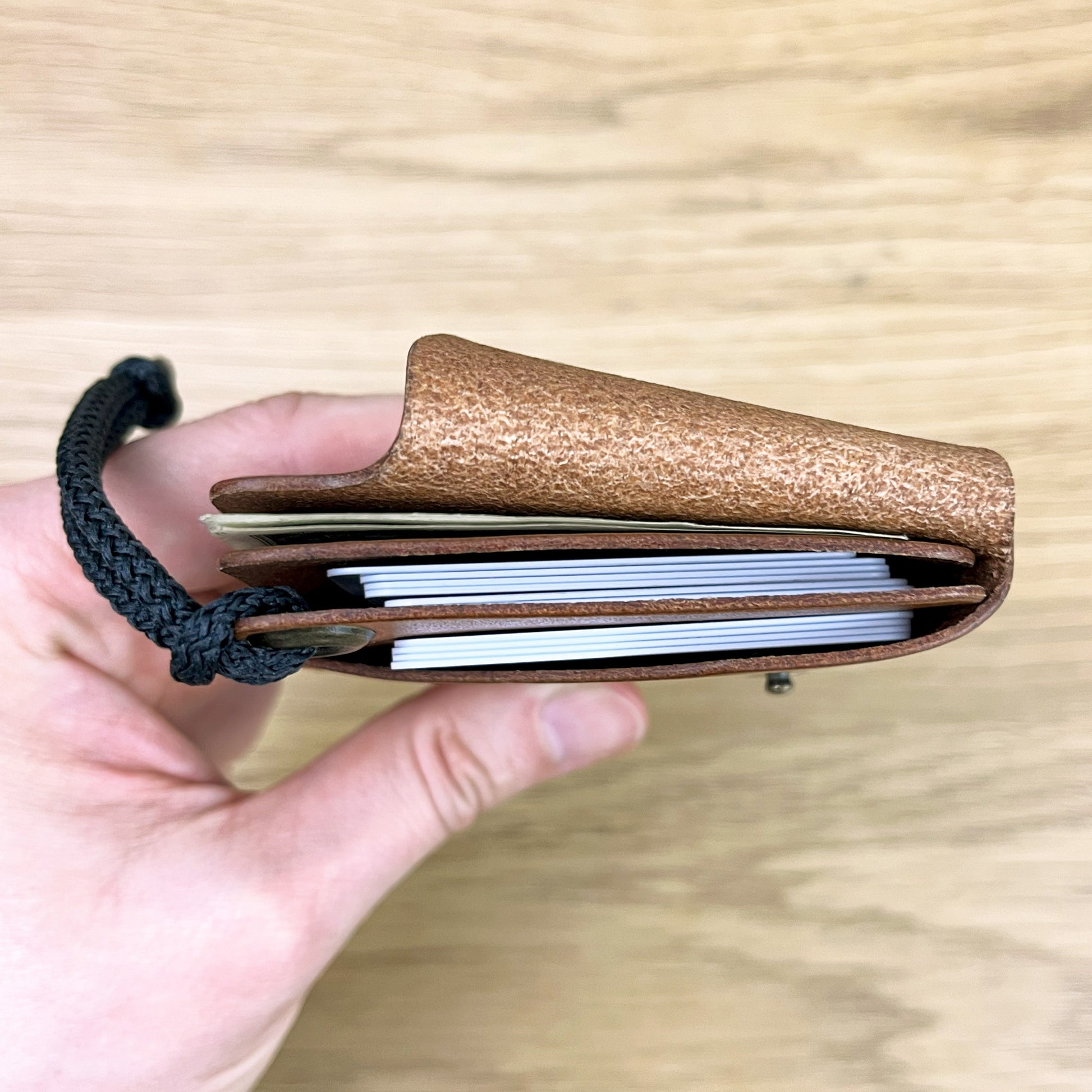 OCEANUS minimalist wallet open — 12 card slots and notes compartment